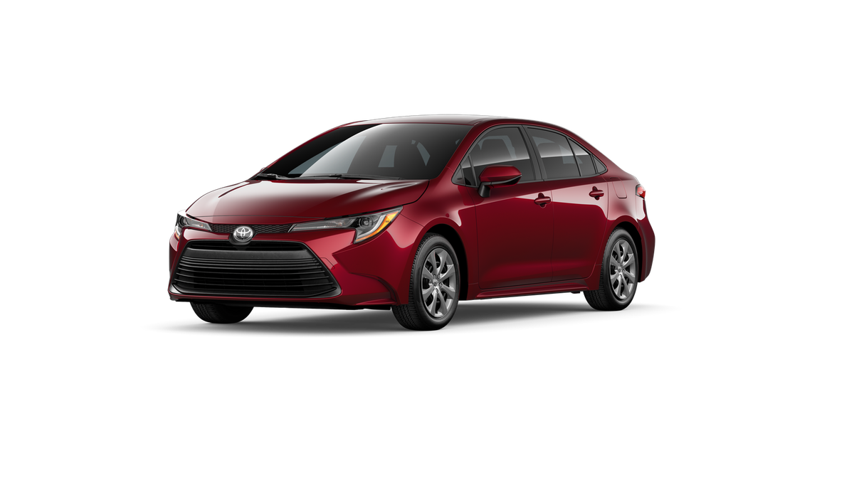 2026 Toyota Corolla LE in Ruby Flare Pearl — front three-quarter view